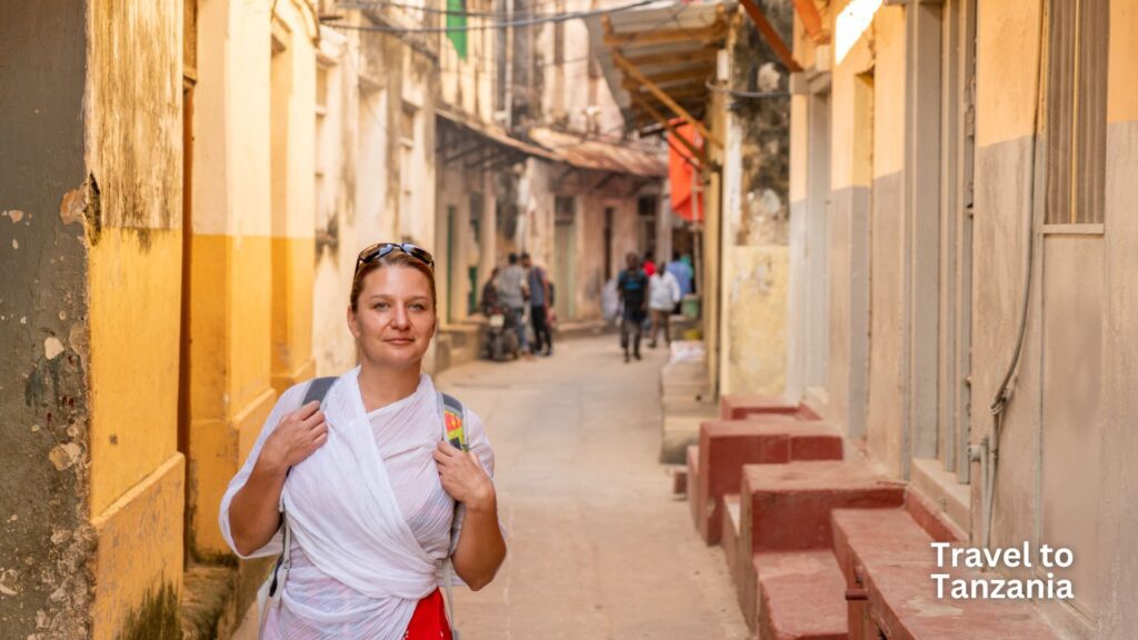 Portrait of female tourist on street in village, Zanzibar, Tanzania